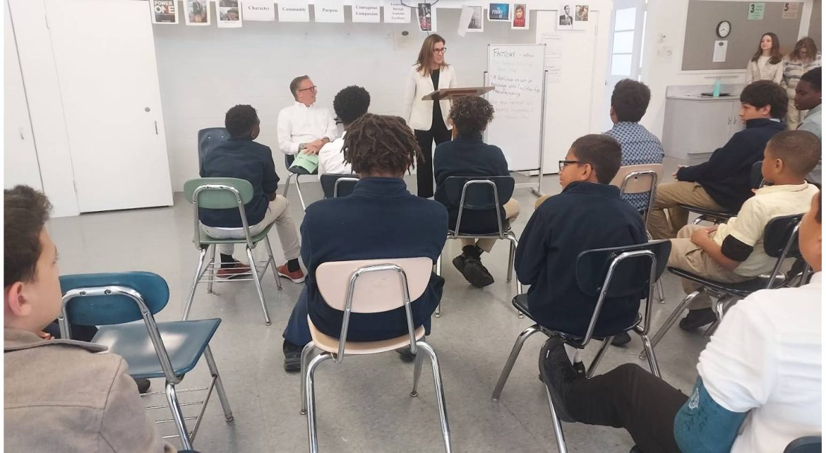 Jamie Boris, speaking, and Paul Lapin, sitting, address CSB students about their careers and work.